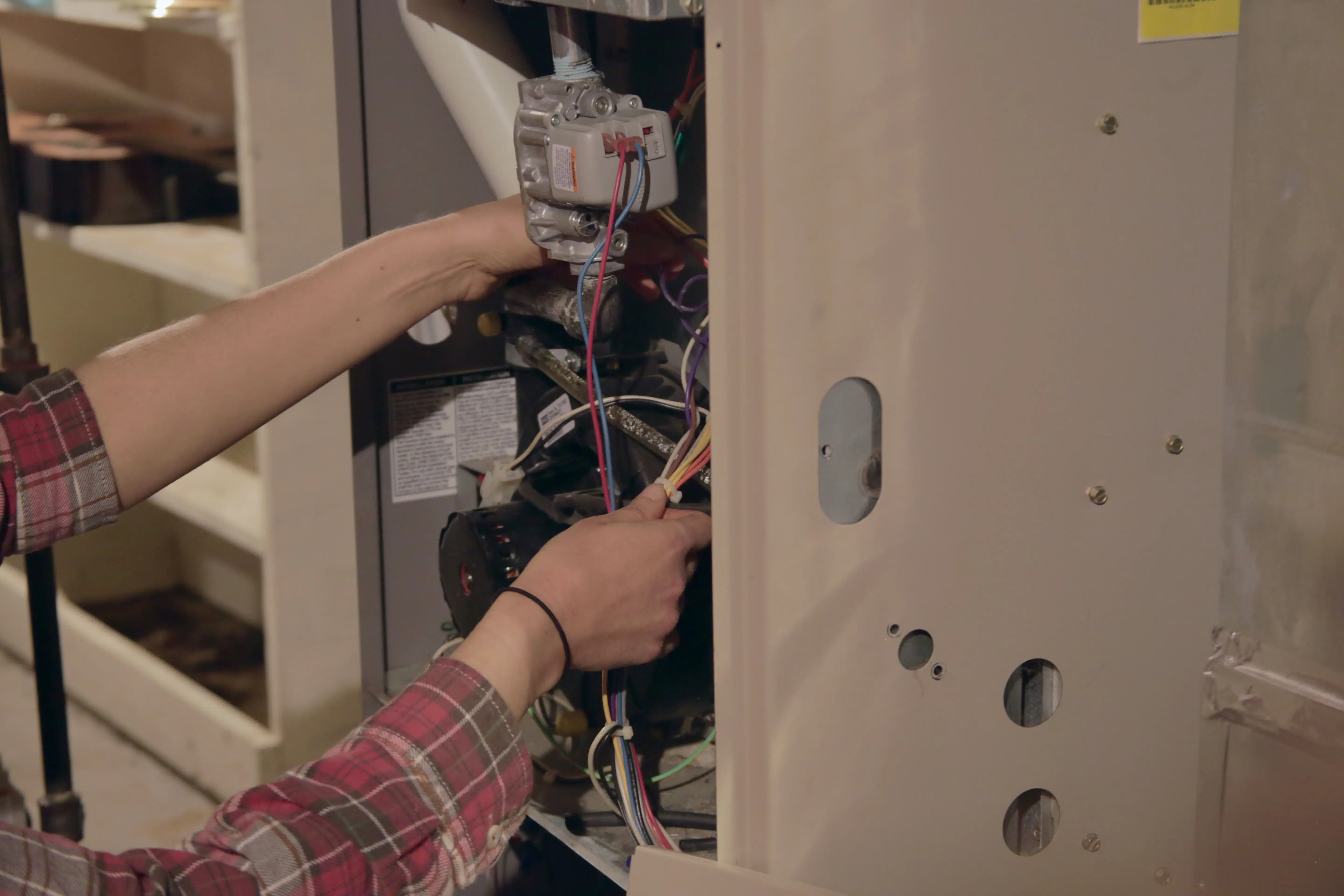 Hands working on furnace