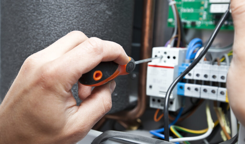 Professional checking heating unit performance during seasonal maintenance
