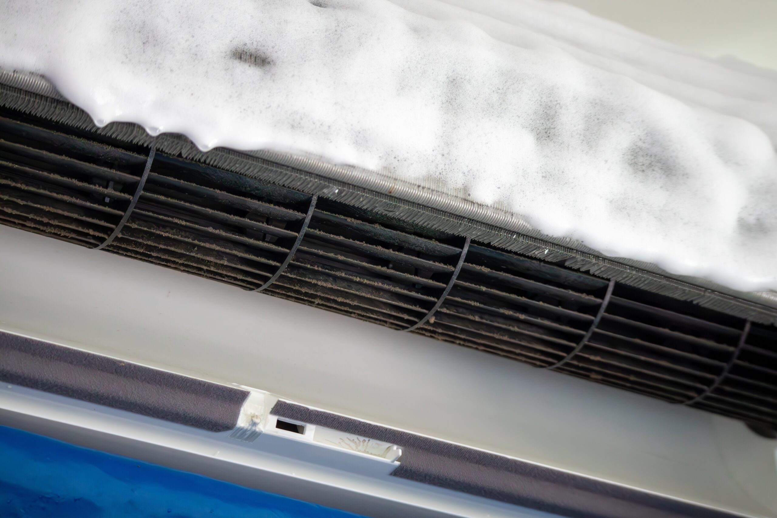 Technician performing AC tune-up to prevent costly repairs on air conditioner