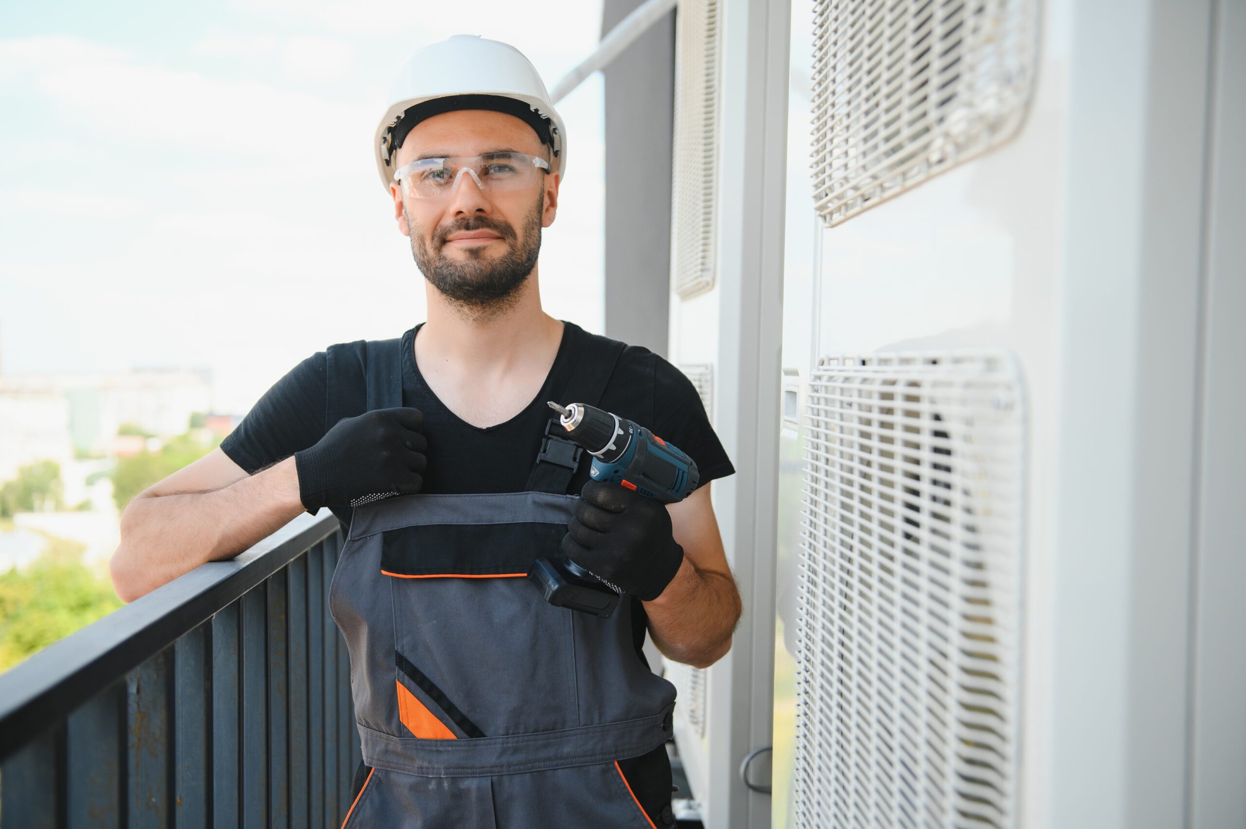 technician installing a new AC system for a property owner with modern cooling equipment