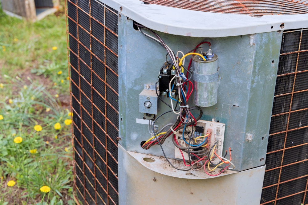 HVAC technician diagnosing loud banging and squealing noises from an air conditioning unit