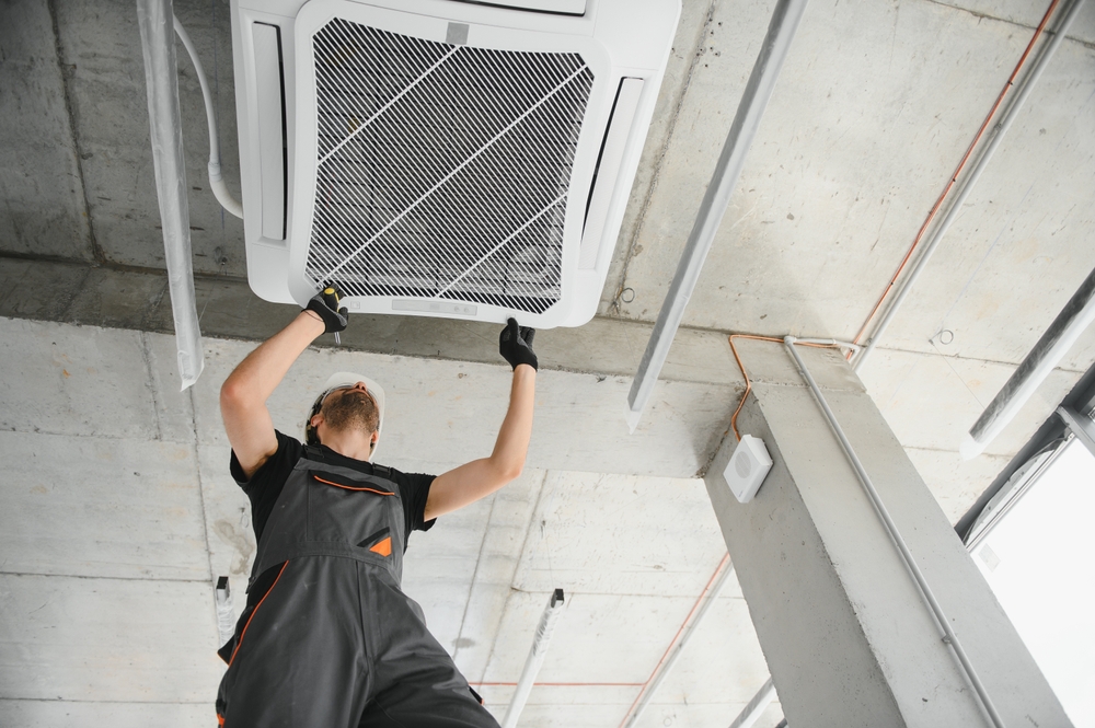 HVAC technician preparing an AC unit for a Texas heatwave at a residential home