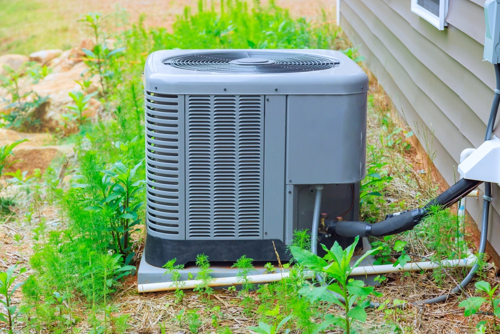 HVAC technician inspecting why AC systems stop cooling properly in a residential home
