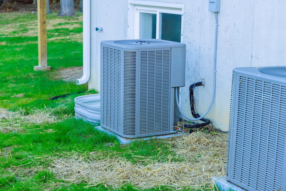 HVAC technician performing air conditioner repair service on a malfunctioning cooling unit