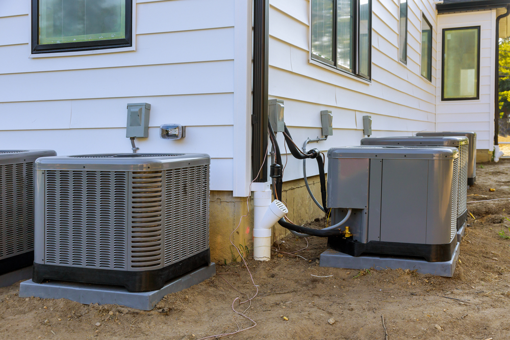 Technician installing a modern air conditioning system in a residential home