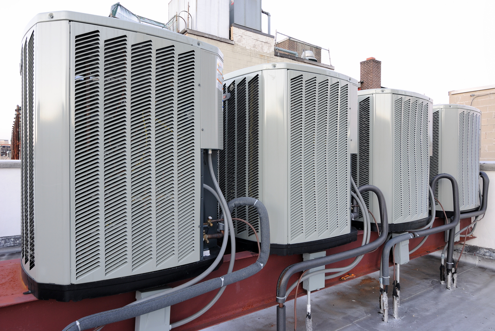 HVAC technician replacing dirty air filters to prevent damage to a residential air conditioner