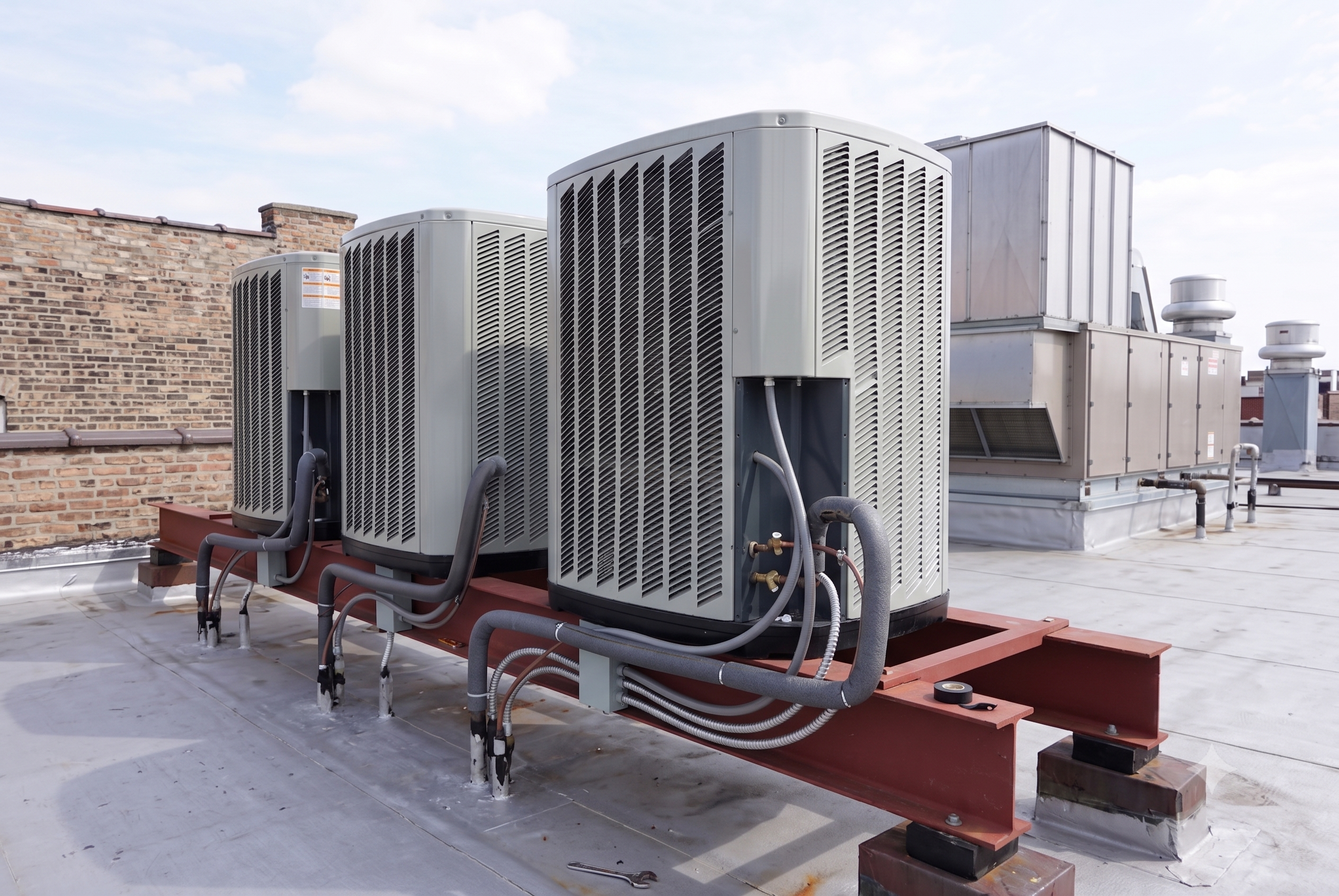 HVAC technician completing an AC installation in a residential home during the ideal installation season